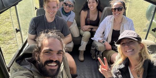 tour group sitting inside a safari vehicle