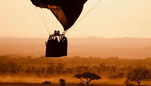 Hot air balloon launching over Serengeti plains