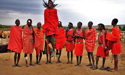 Maasai villager jumping with group