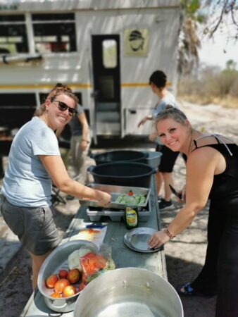 Travelers preparing lunch next to overlander