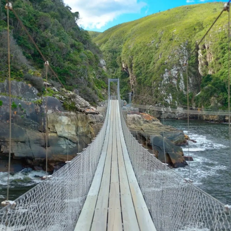 The picturesque Storms River bridge hanging between two ocean cliffs