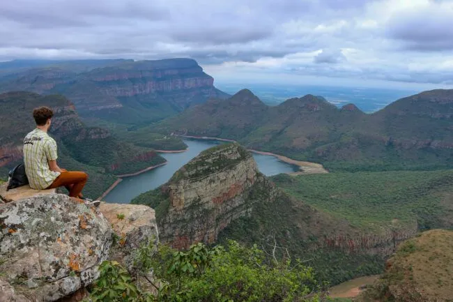 Traveler pondering by overcast Blyde River Canyon