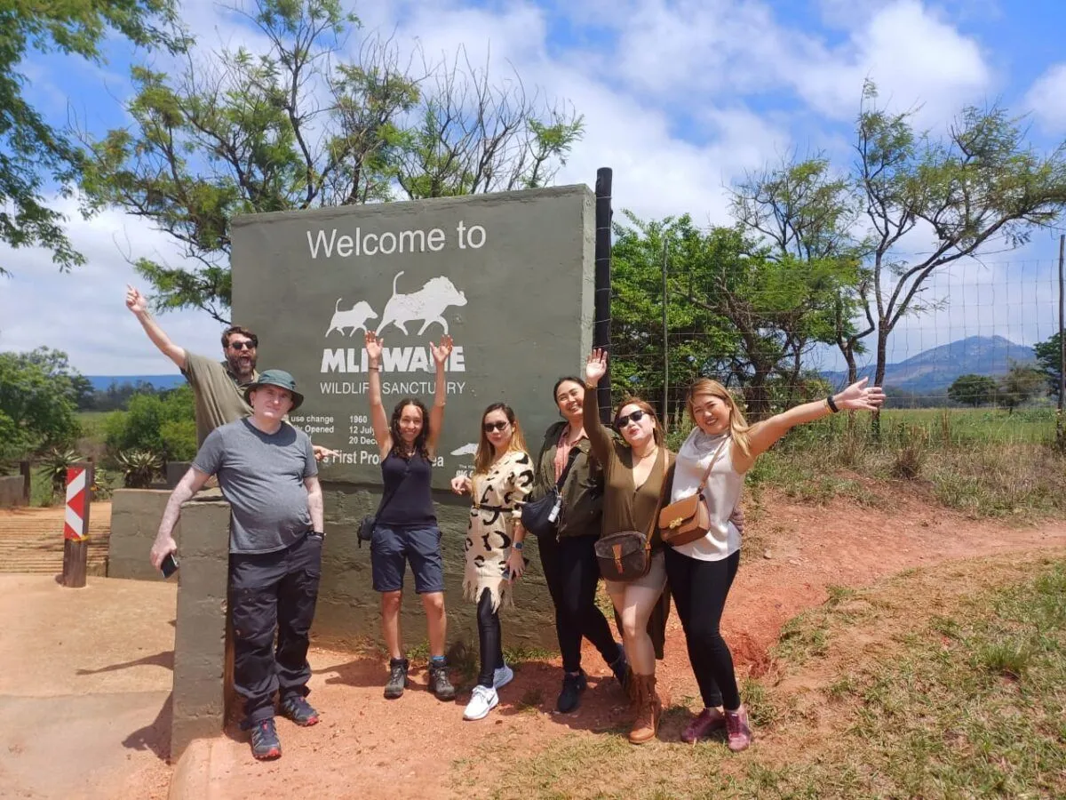 group of people standing outside a wildlife sancturary