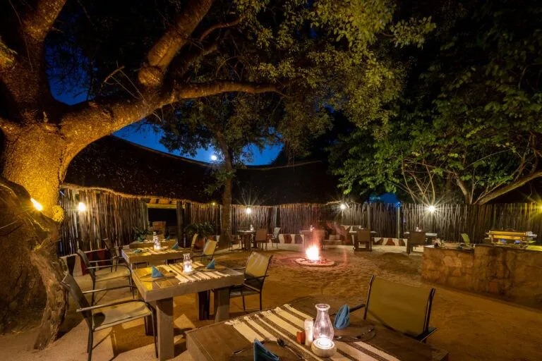 boma with chairs and tables and a fire going