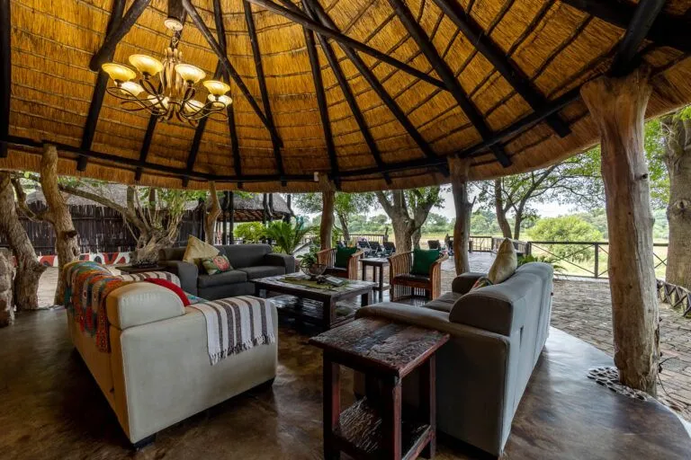 lounge area under a lapa with comfortable couches