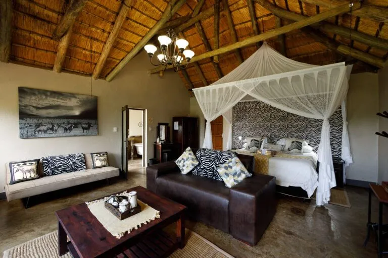 bedroom with canopy bed, sleeper couch, couch and table