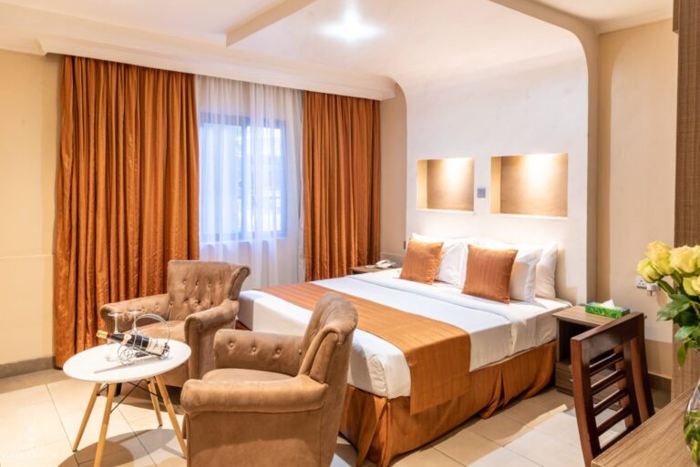 beautiful bedroom with a bed, table and chairs