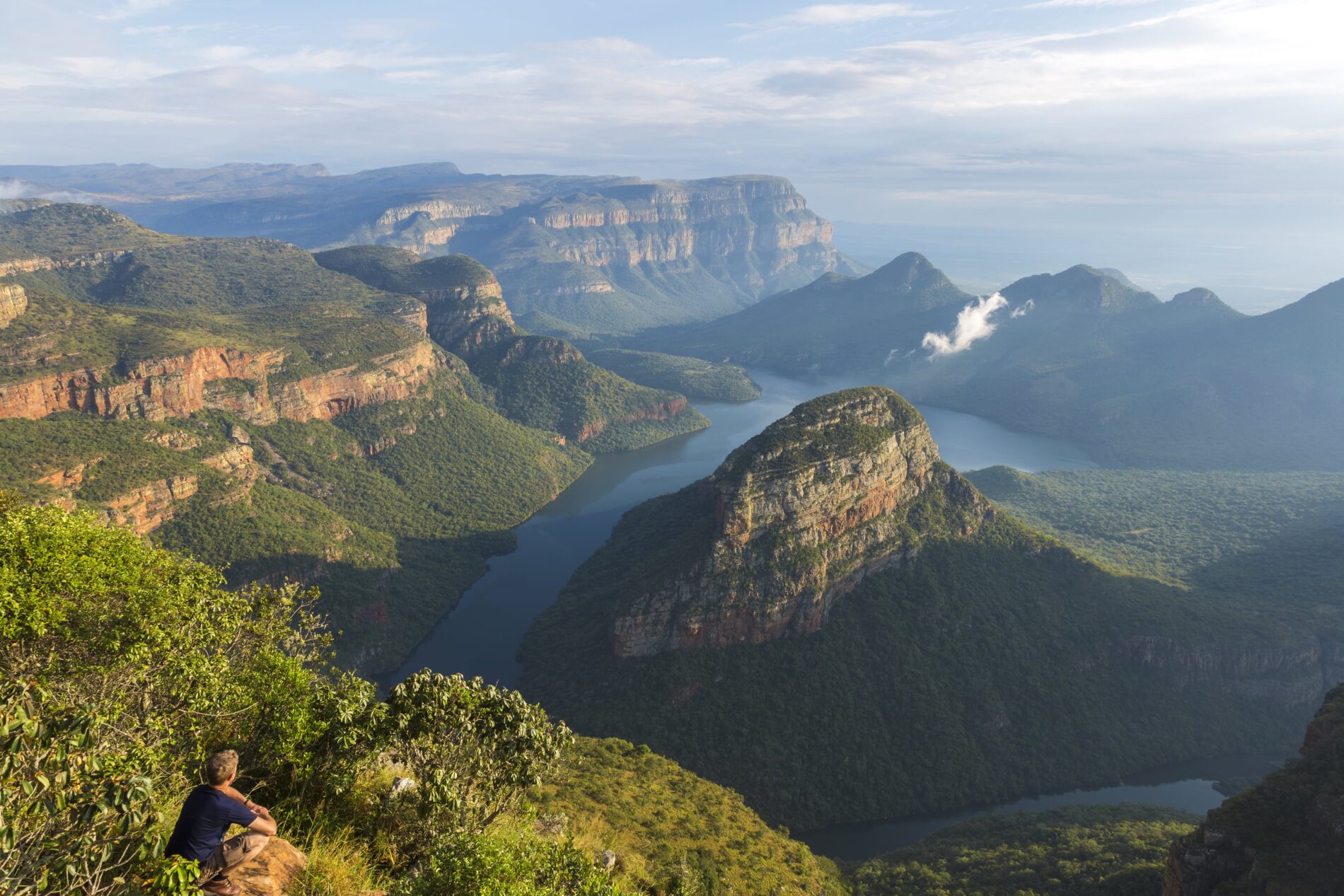 stunning wide angle view of a valley with water and greenery