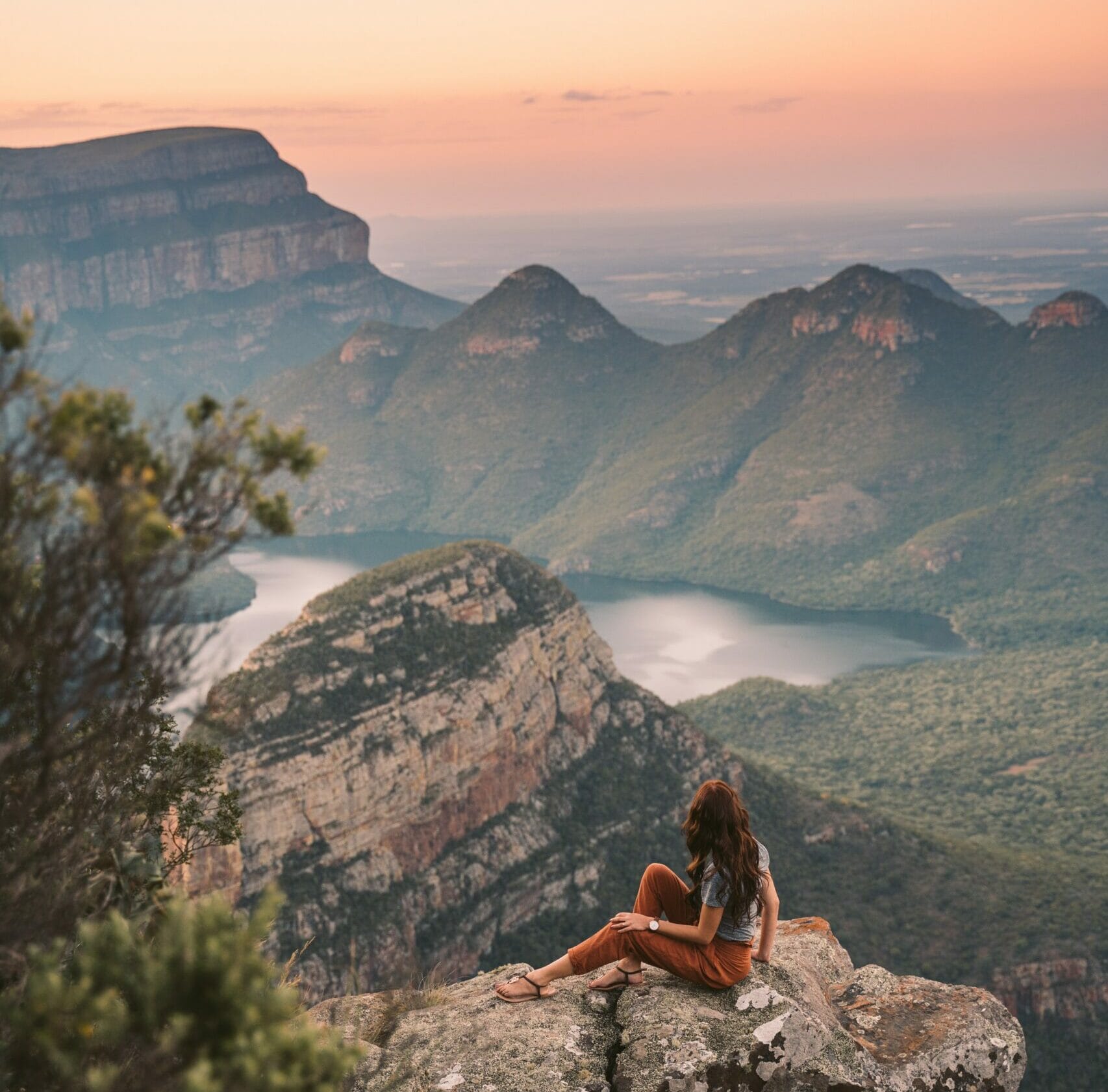 Traveler overlooking Blyde River Canyon at sunset