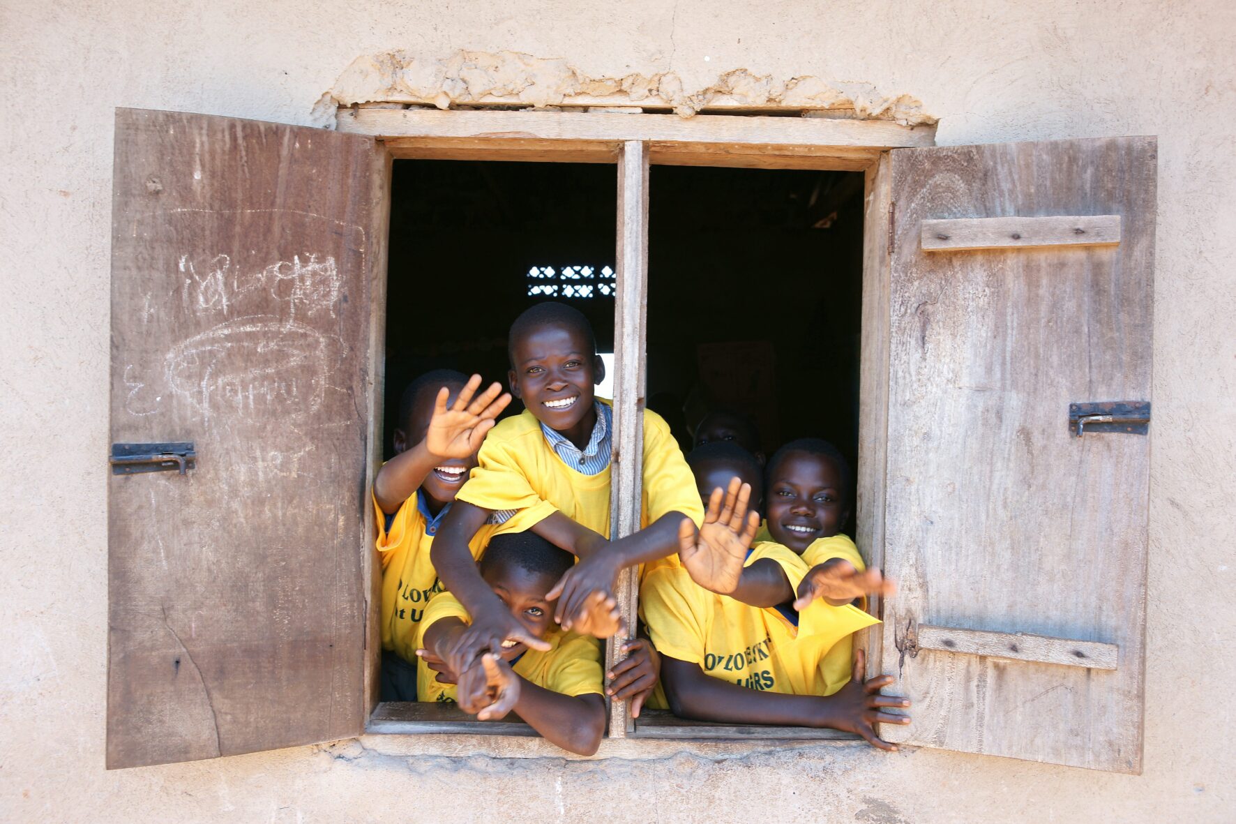 Children from school in Uganda through window