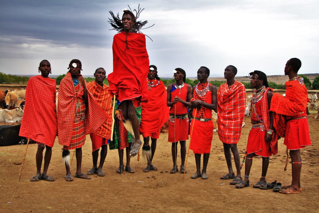 Maasai villager jumping with group