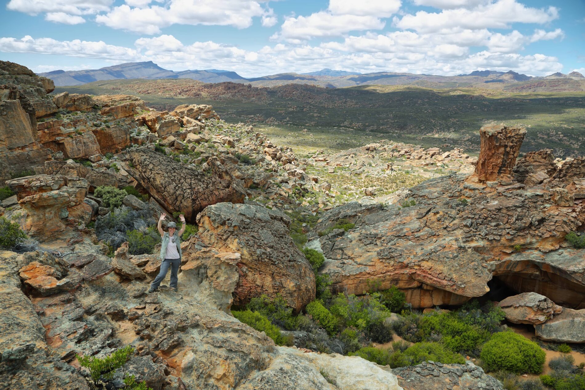 Woman poses at Stadsaal caves in Cederberg nature reserve, South Africa