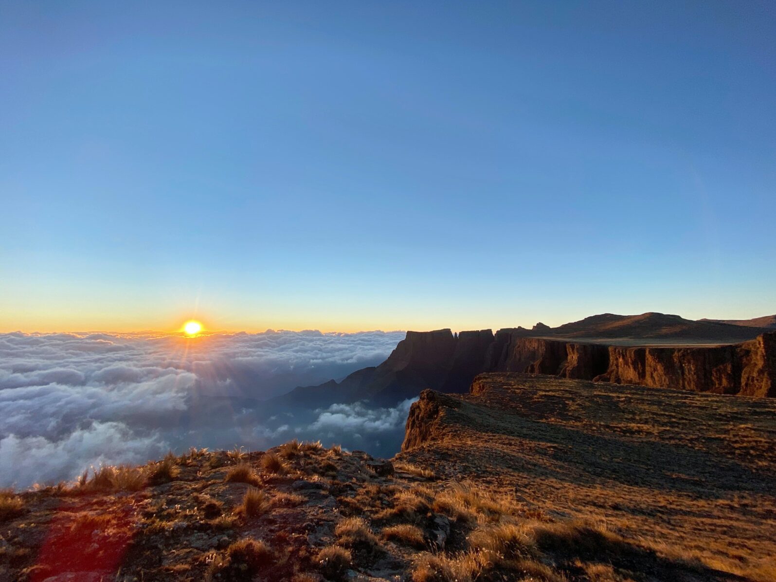 Drakensberg sunset with cloud cover beneath mountains