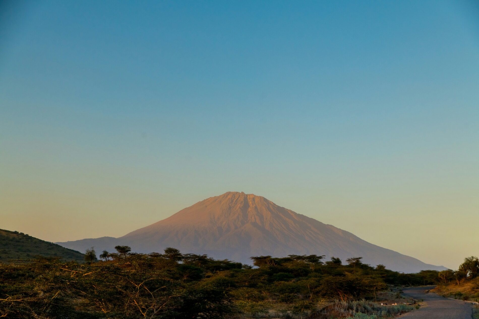Sun falling on the peaks of Mount Meru in Tanzania