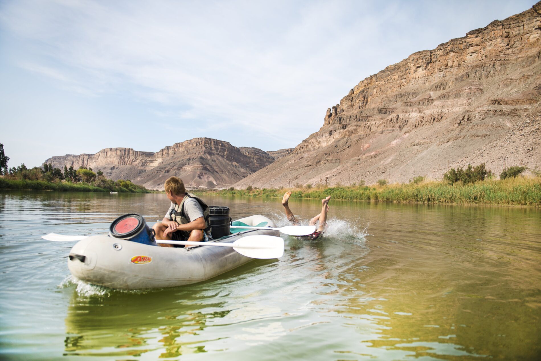 Man falling behind canoe on Orange River paddle