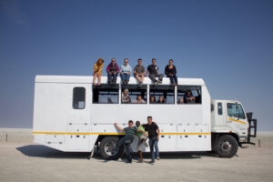 Group pic on top, inside & in front of overland vehicle in Nata Pans