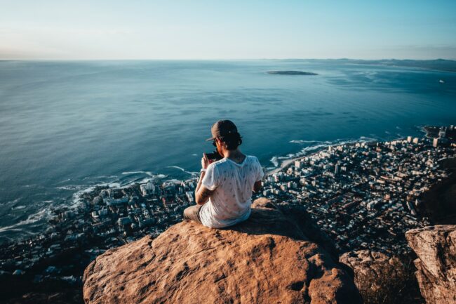 Top of Lions Head, Cape Town with tourist capturing view