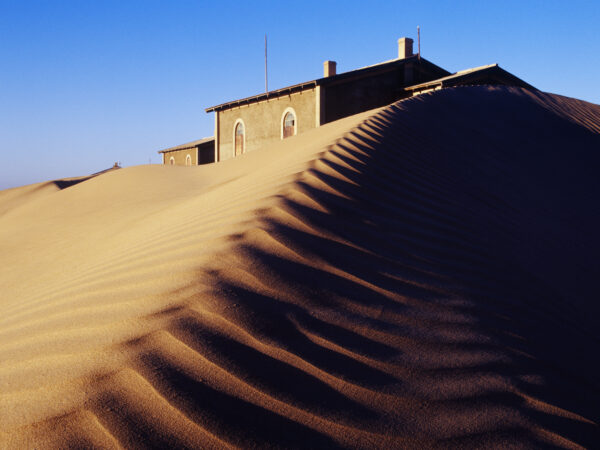 Deserted house buried in sand, Kolmanskop Ghost Town, Namibia