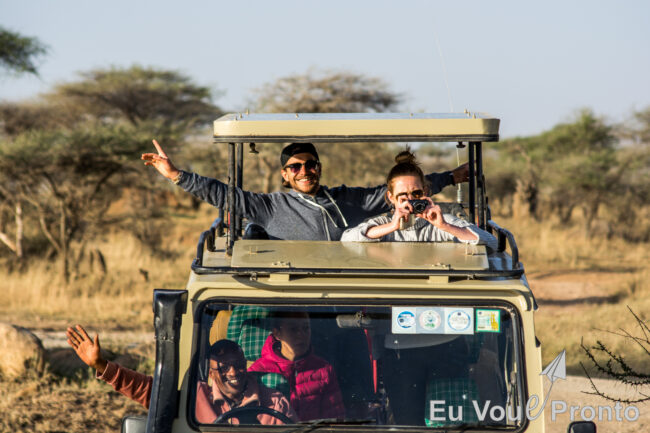 Happy couple in pop-up roof safari vehicle in East Africa