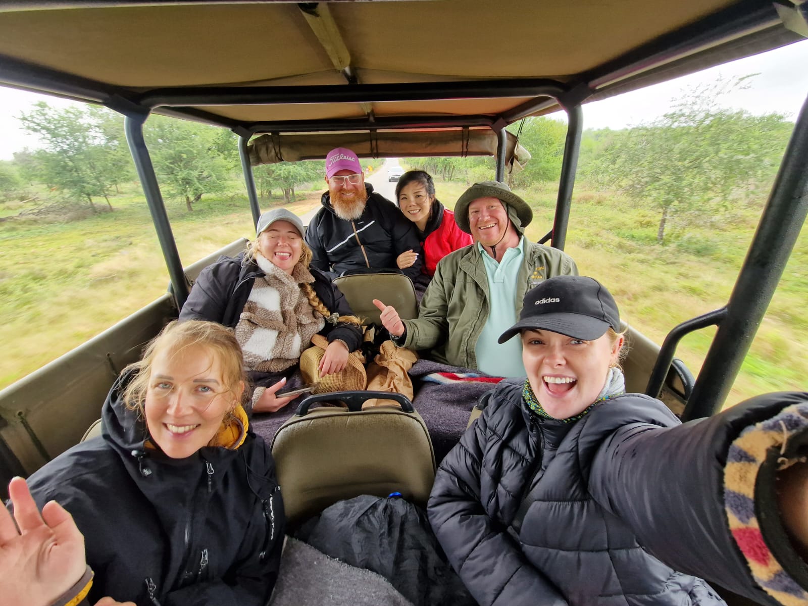 people on a safari vehicle taking a selfie