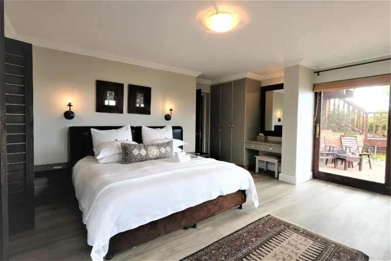 bedroom with a double bed and dressing table with a patio outside the door