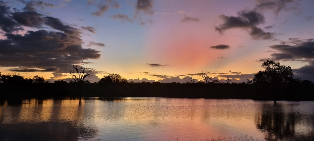 stunning sunset with clouds, mountains and water