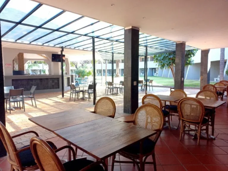 lodge outside dining area with tables and chairs under a roof