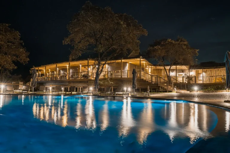 night view of a lodge over the swimming pool