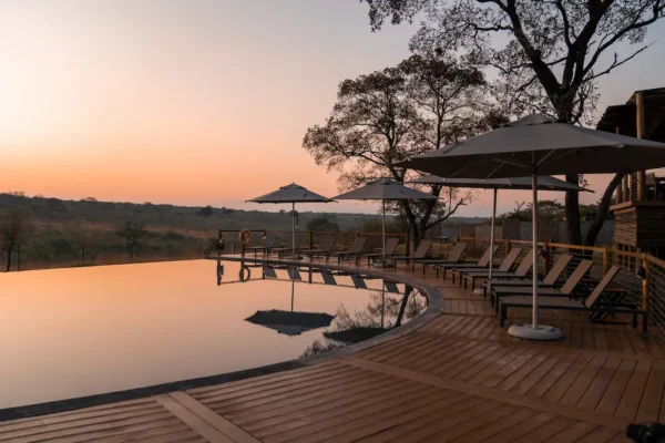 sun setting over a pool