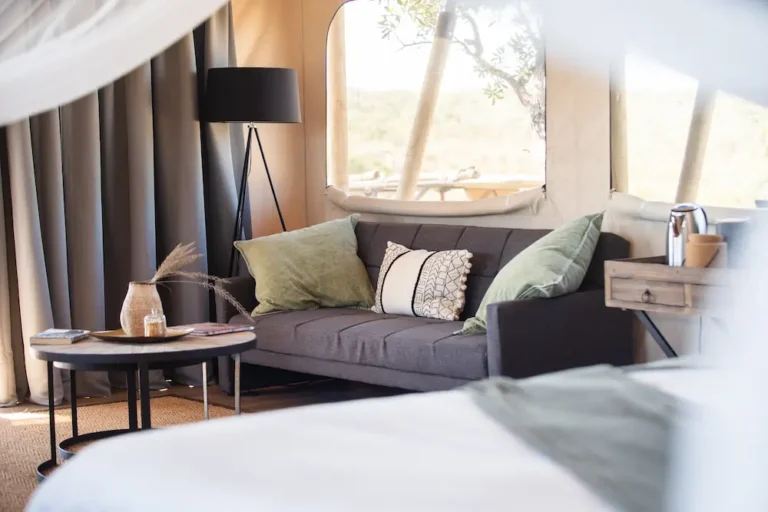 inside of a luxury tent with a couch and table