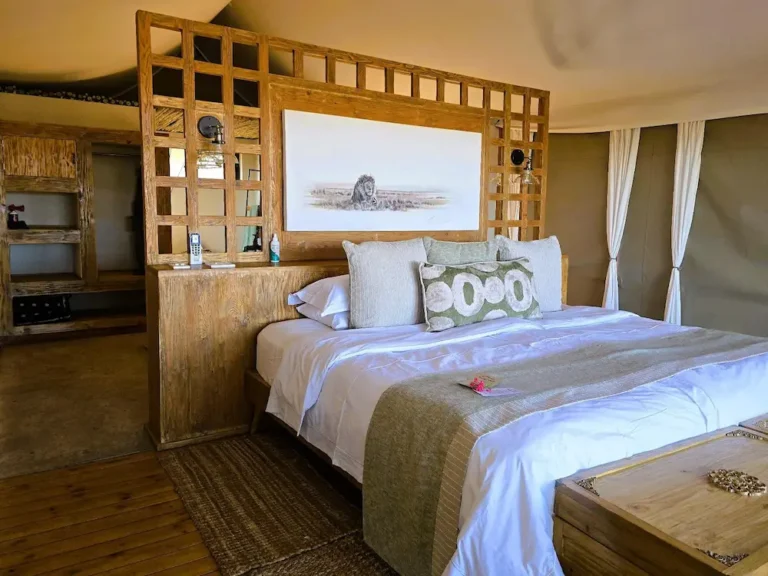 front view of a luxury tented camp with a double bed