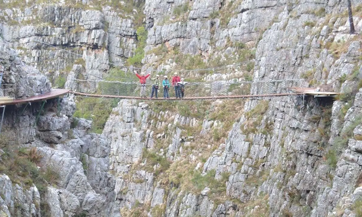 Group standing on suspension bridge in Elgin